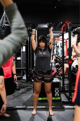 Woman training on cable machine at a personal training gym in Singapore